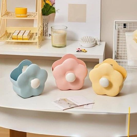 Flower-shaped makeup brush holders set in blue, pink, and yellow