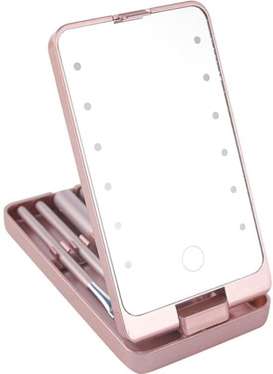 Pink lighted makeup mirror with brush storage case open, showing five makeup brushes