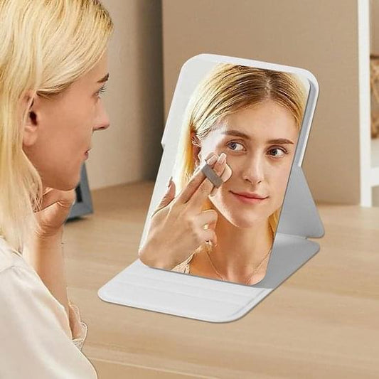 White foldable makeup mirror on stand, frameless reflective panel for applying makeup