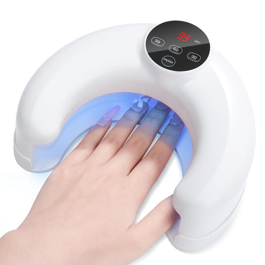 White UV/LED nail lamp with curved hood and blue light curing a hand
