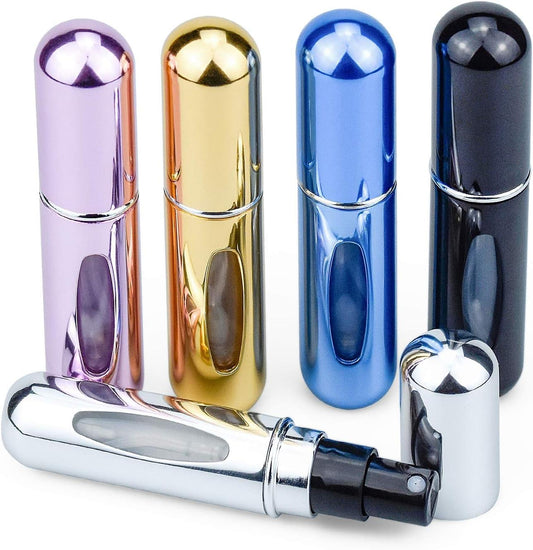 Perfume atomizer bottles with chrome nozzles and viewing windows in purple, gold, blue, and dark