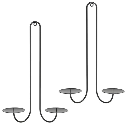 Black wall-mounted candle sconces with tall U-shaped frames and round plate bases