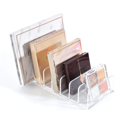 Clear acrylic makeup organizer with open front and angled dividers for palettes
