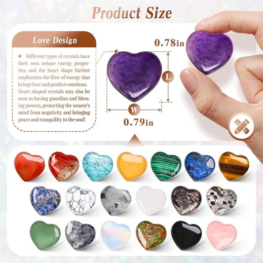 Hand holding a purple heart-shaped crystal stone among assorted sizes