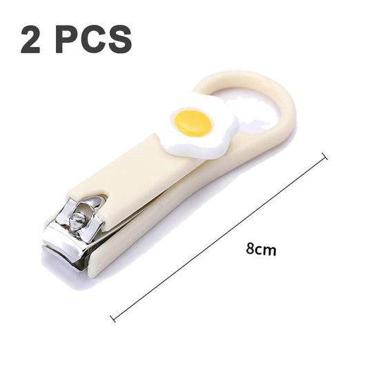 Two fingernail clippers, cream handle with egg detail and mint handle with owl detail.