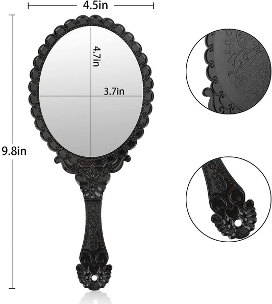 Black oval handheld mirror with ornate scalloped edge; size markings in inches shown