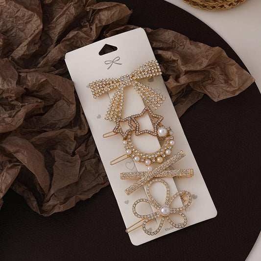 Rhinestone hair barrette set on card, five gold-tone clips with pearls