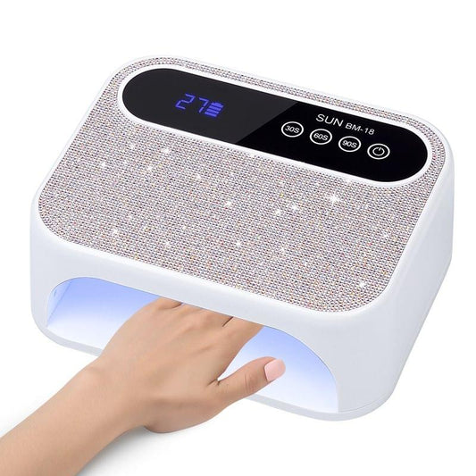 Sparkly diamond UV nail lamp with glowing blue light inside and timer buttons