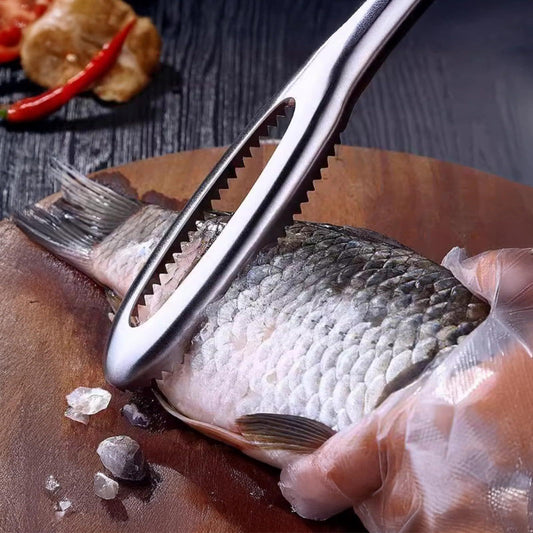 Stainless steel fish scaler removing scales from fish on cutting board