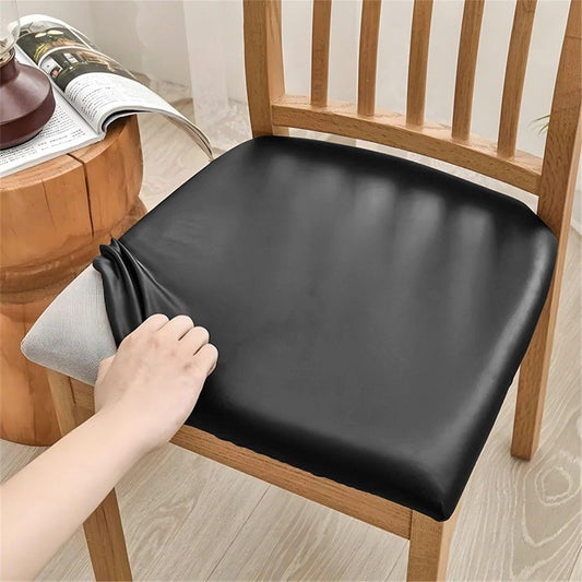 Black seat cushion cover with stretch fit, corner tucked on wooden chair