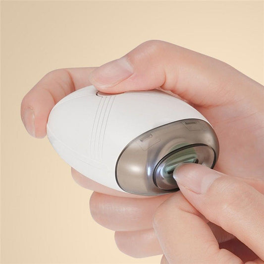 Electric nail grinder, white body with dark top, close-up of grinding head