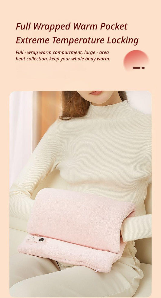 Pink hand warmer pouch held under the arm against a sweater