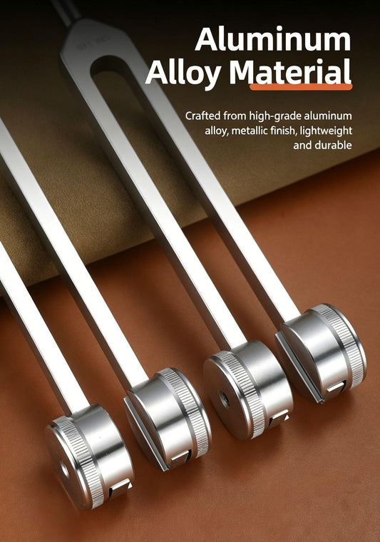 Metal tuning forks with knurled ring ends, close-up of four silver forks on handles