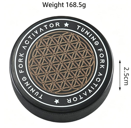 Round black carrying case with gold geometric tuning pattern medallion
