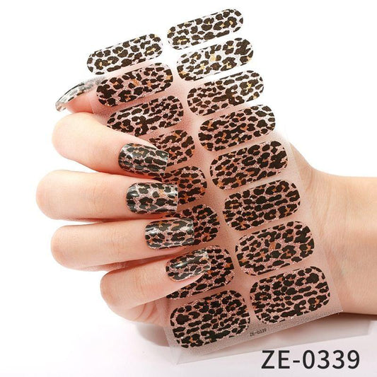 Leopard print nail stickers with black and tan spots on clear film
