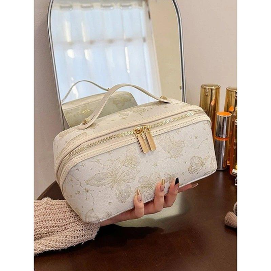 Vintage-style makeup bag in light cream with floral print and gold-tone zip