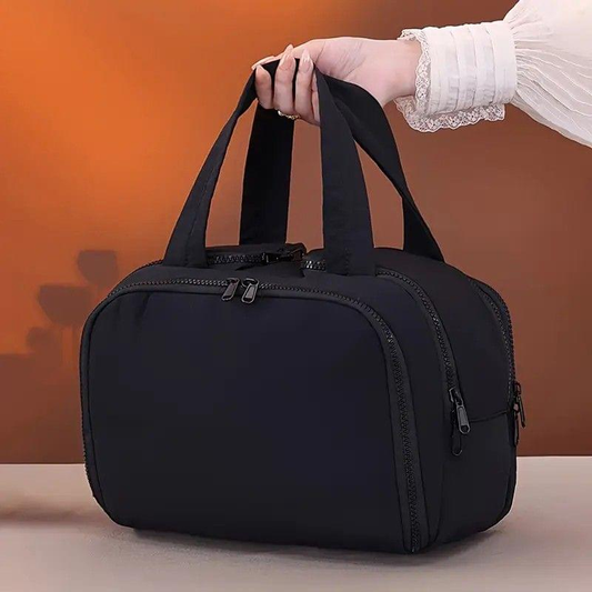 Black large travel toiletry bag with top handle and front zip pocket