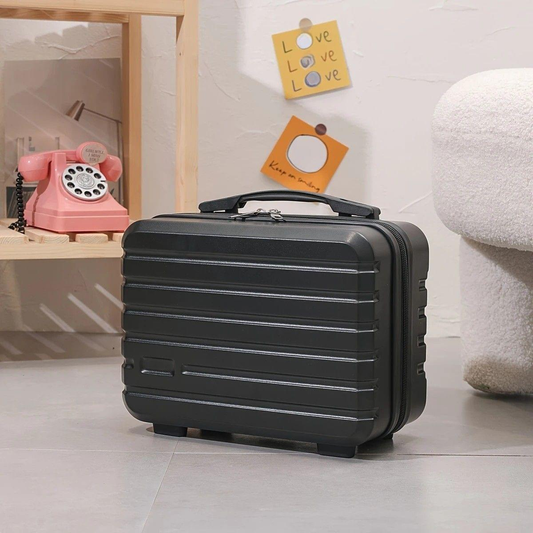 Black mini makeup case with zip closure and top handle, ribbed hard shell.