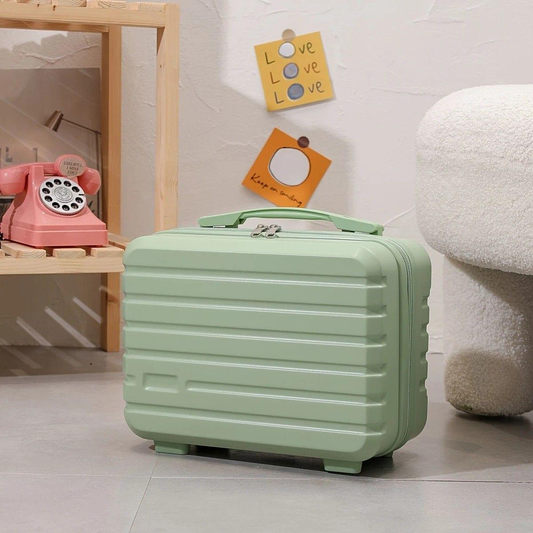 Light green mini makeup case with ribbed shell and top handle, side view on floor.