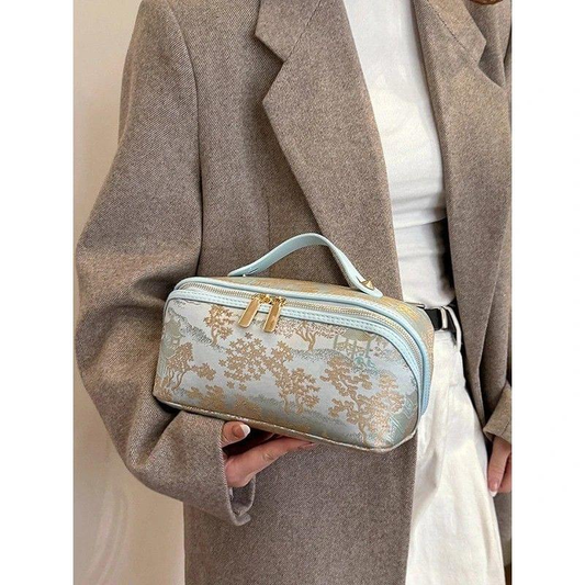 Blue patterned makeup bag, double zipper pulls, top carry handle