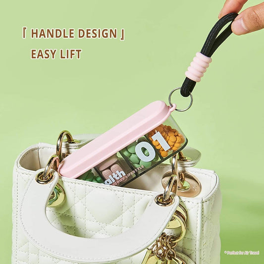 Compact four-compartment pill box with keyring handle, light pink lid on white base