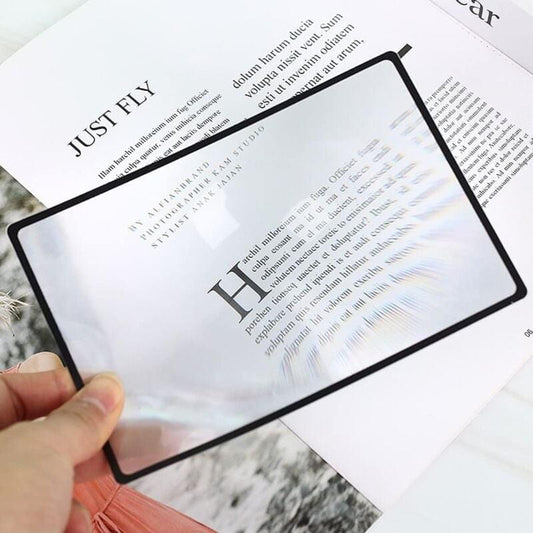 Square Fresnel magnifier sheet with black border over printed text