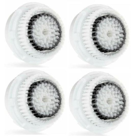 Set of round facial brush heads with white bristles on pale gray bases