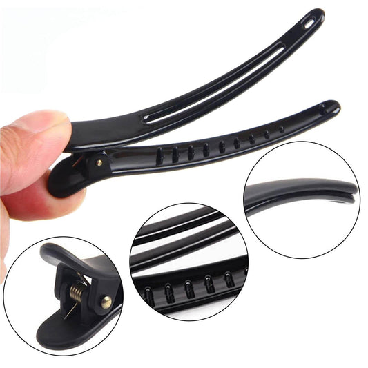 Black hair clip with spring hinge and grooved teeth detail