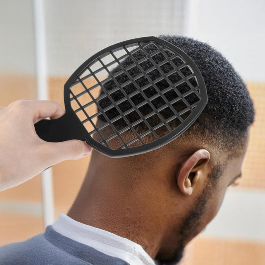 Black hair pick comb with grid side held to short curly hair