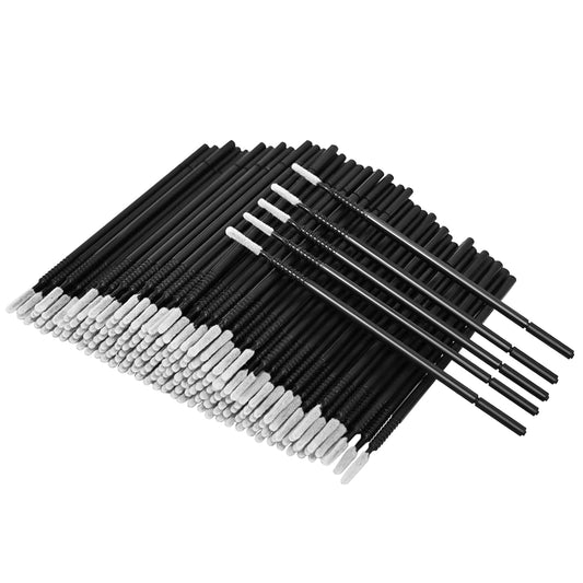 Disposable micro brush wands with black handles and white bristles, angled view