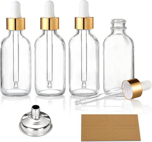 Clear glass dropper bottles with white caps, gold collars, funnel, and kraft labels set