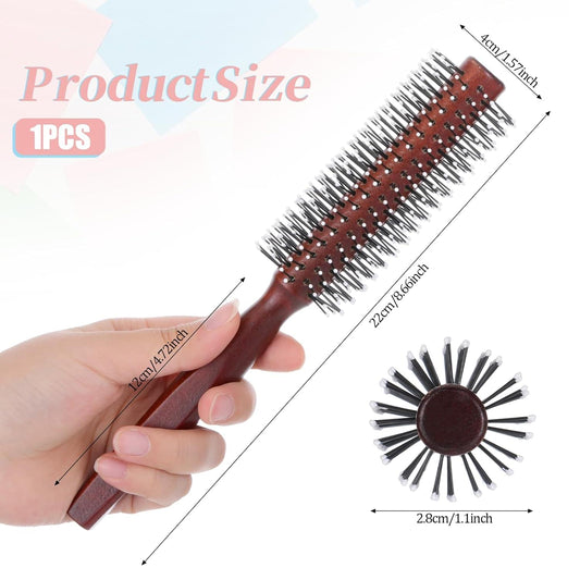Round styling hair brush held in hand, burgundy handle with white bristle pins