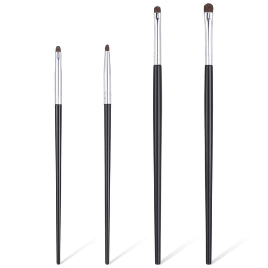 Set of four mini eye makeup brushes with silver ferrules, dark bristles, and black handles.