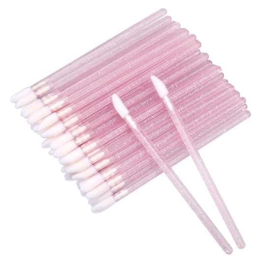 Disposable lip gloss applicator wands with pink glitter handles and white bristles