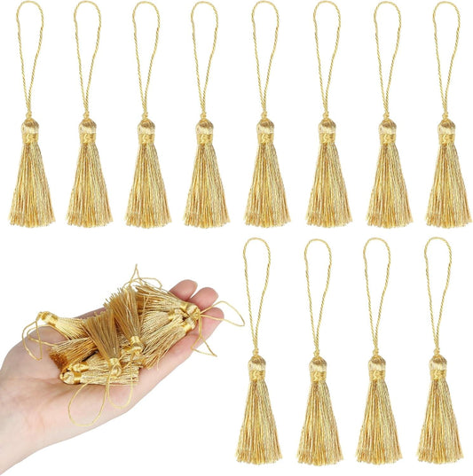 Gold mini tassels with cord loops, lined up and held