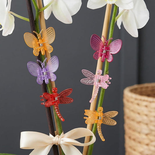 Multicolor butterfly vine clips on wooden stakes, pink, purple, orange, and red