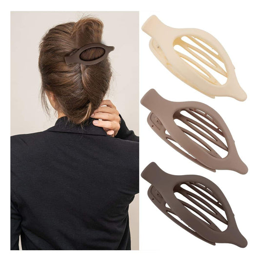 Hair claw clip, dark brown/charcoal with oval cutout, holding a low bun.