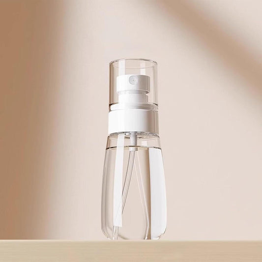 Refillable 60 ml spray bottle with white pump and clear translucent body