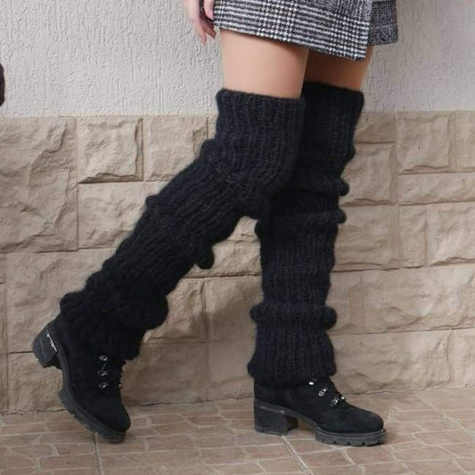 Dark knitted leg warmers with thick ribbed pattern and foldover cuffs