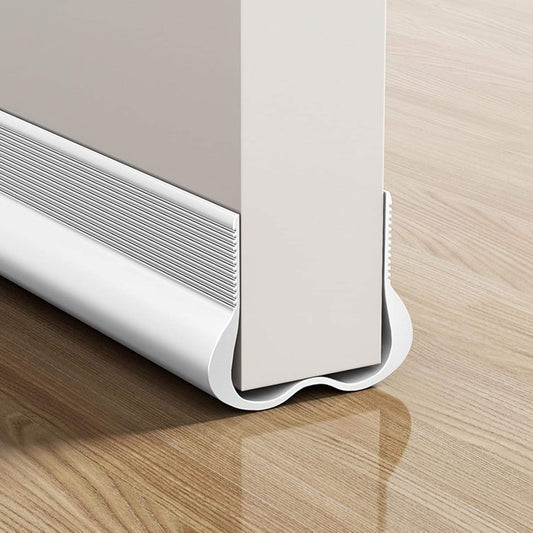 White door draft stopper strip with cushioned base and curved sealing lip