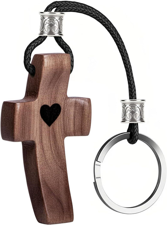 Wooden cross keychain with black braided cord, heart in center, and metal key ring