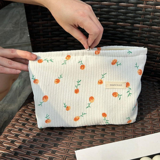 Large corduroy cosmetic bag in off-white with orange cherry print and top zipper