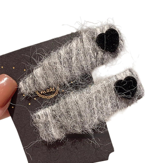 Fuzzy hair clip set with gray fabric and black heart accents, two clips