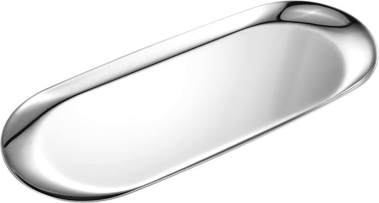 Stainless steel oval vanity tray with smooth, reflective mirror-polished surface and raised edges.