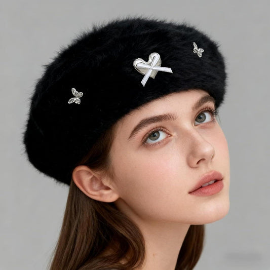 Black faux fur beret with silver bow and butterfly metal gems, side view on model