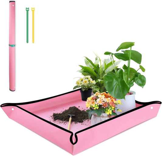 Pink portable potting mat with black edges and corner loops, holding soil and plants