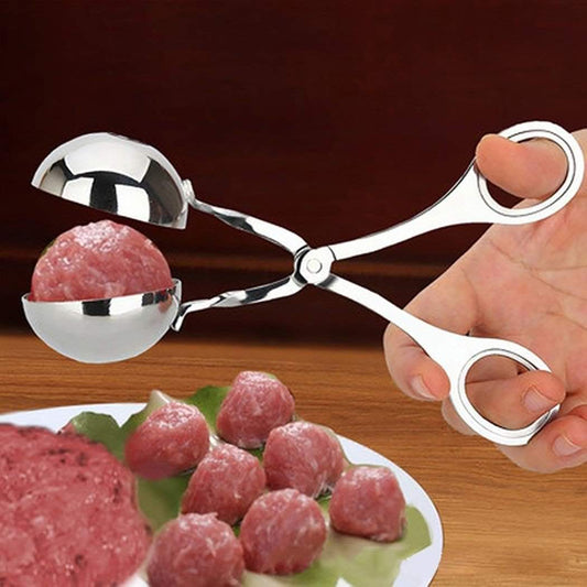 Stainless steel scoops shaping meatballs on a tray with one person holding tongs