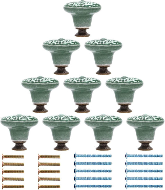 Pack of round green ceramic dresser knobs with embossed floral detail and screw base