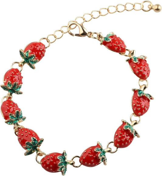 Gold-tone strawberry charm bracelet with red berry links and green leaf charms