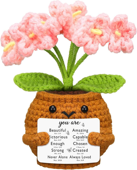 Handmade crochet pot doll with pink forget-me-not flowers and verse card, close-up